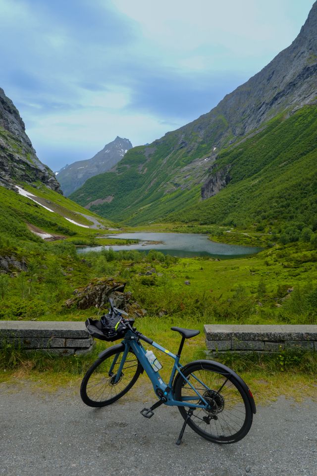 A blue e-bike in front of a fjord in Norway